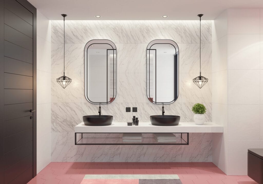 Salle de bain luxueuse avec des carreaux de céramique rose clair en nid d'abeille et de grands carreaux de céramique gris clair et blanc mat. Long meuble-lavabo avec finition en pierre Corian blanche, étagère métallique noire et lavabo rond en céramique noire, robinet de lavabo en cascade en acier inoxydable et plante décorative. Douche à l'italienne avec grands carreaux de céramique clairs, panneau de douche noir en acier inoxydable, étagère murale décorative et carreaux de sol longs et étroits en pierre naturelle gris foncé.